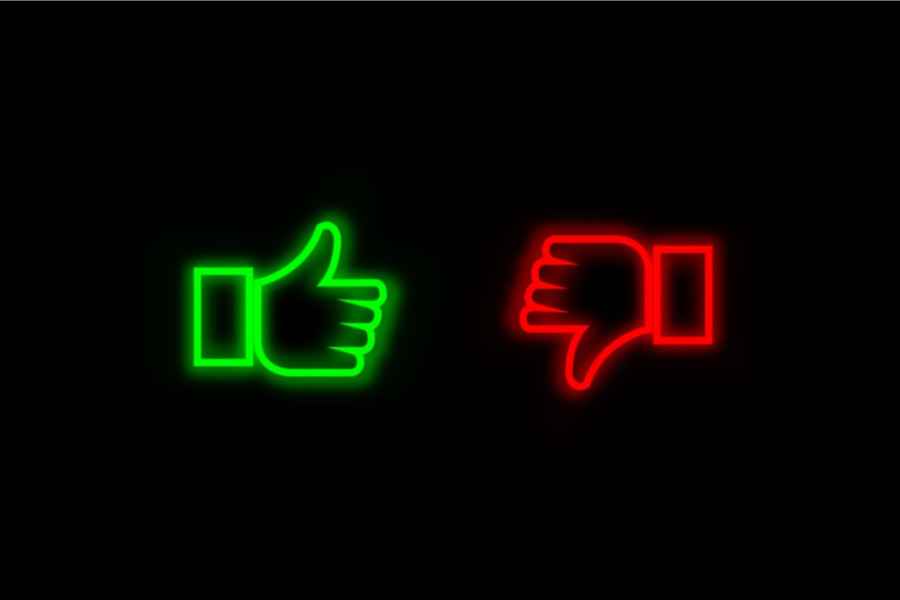neon thumbs up and thumbs down on black background